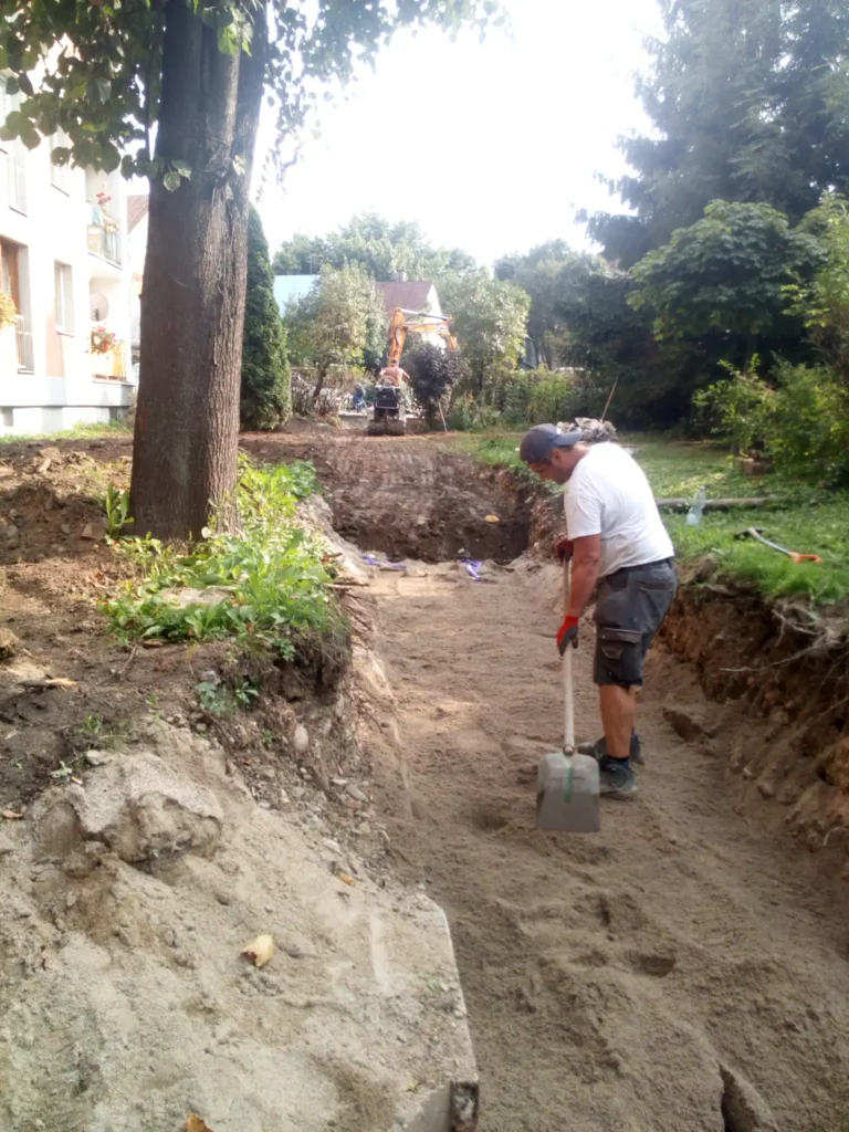 Zasypany wykop ciepłowniczy przygotowany do rekultywacji terenu.